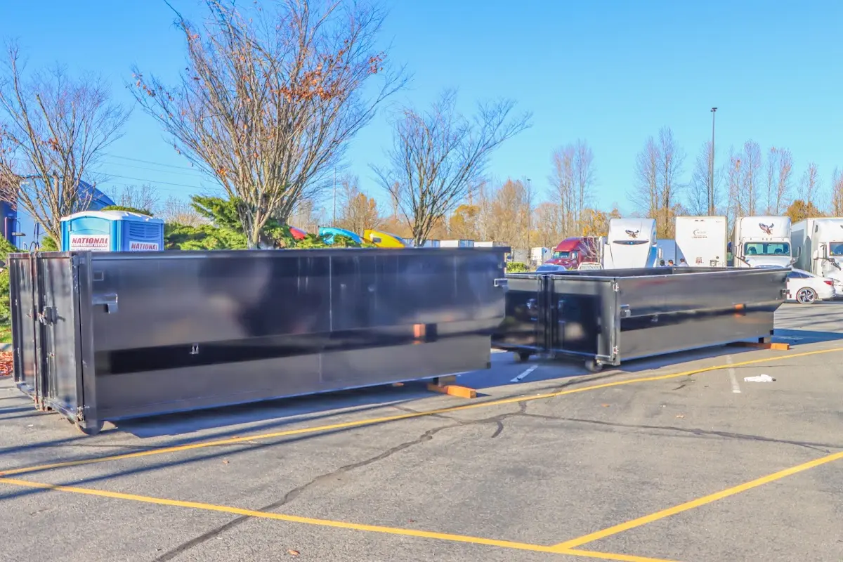 Professional dumpster rental service with roll-off container on residential driveway in Satellite Beach